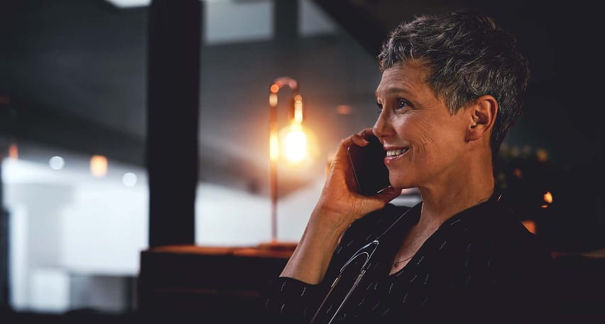 woman with short hair talking on phone