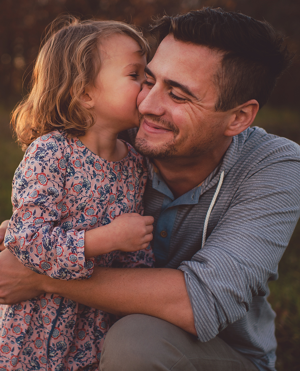 Family care is lifecare. Image shows man holding his young daughter