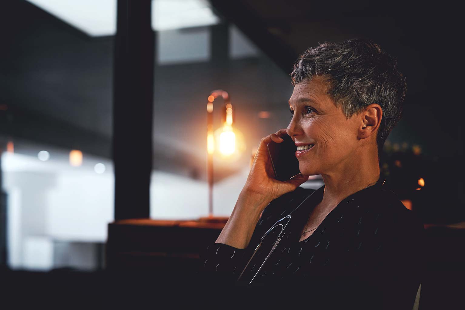woman with short hair talking on phone